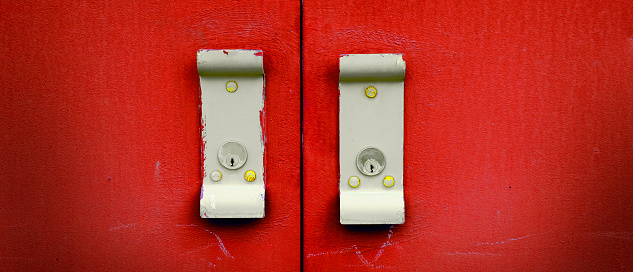 Red industrial doors textured metal door with handles for opening and locks