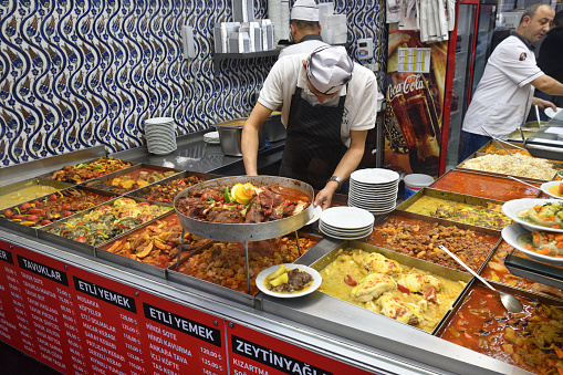 Istanbul, Turkey â December 08, 2023: Take away cafe with traditional Turkish food on a city street. Focus on a chef