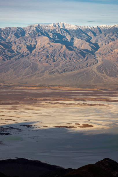 Panoramic majesty: Breathtaking vista unfolds as Dante's View provides a majestic overlook of the vast Badwater Basin, framed by the distant silhouette of Telescope Mountains