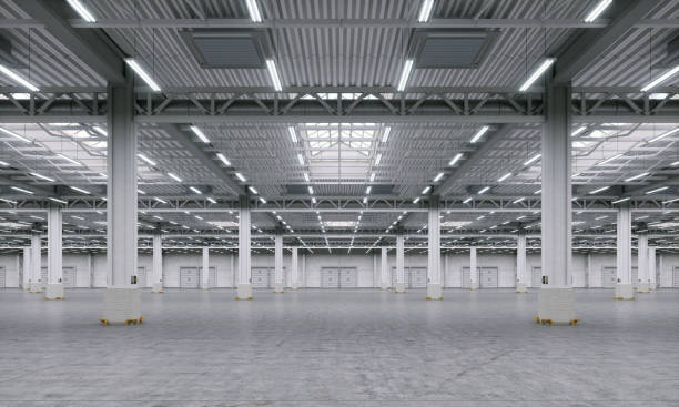 istock Big empty warehouse interior space. Empty industrial storage room with concrete floor and pillars construction. 1960318722