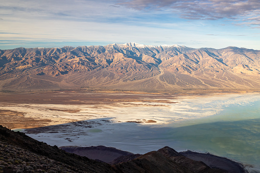 Panoramic majesty: Breathtaking vista unfolds as Dante's View provides a majestic overlook of the vast Badwater Basin, framed by the distant silhouette of Telescope Mountains