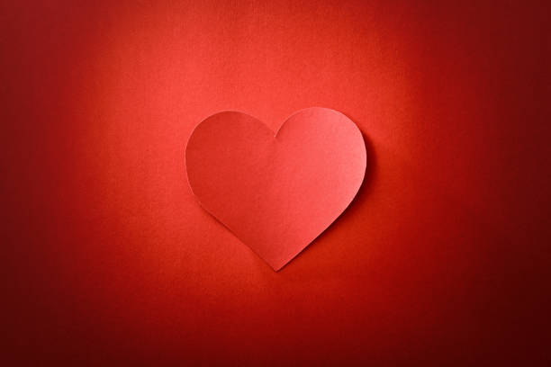 istock Cutout of heart isolated on red textured and gradient background 1960329093