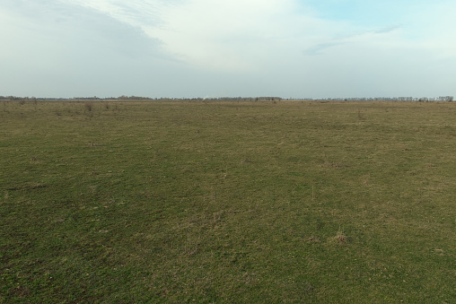 Steppe plain on a cold evening. Beautiful sky over the field. Landscape.