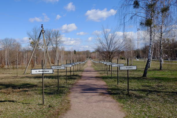 alley with the names of abandoned villages in the zone of the chernobyl nuclear disaster. memorial complex to resettled villages in exclusion zone. signposts with names of villages in cyrillic. - cyrylica zdjęcia i obrazy z banku zdjęć