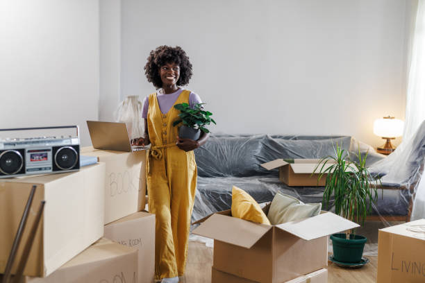 istock Young woman moving in and using a laptop 1960345321
