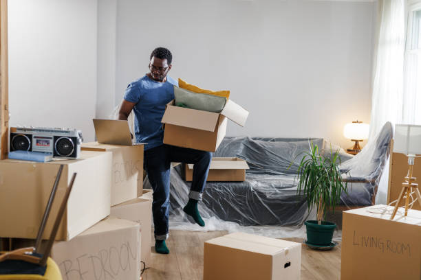 istock An African-American man using a laptop while unpacking moving boxes 1960345348