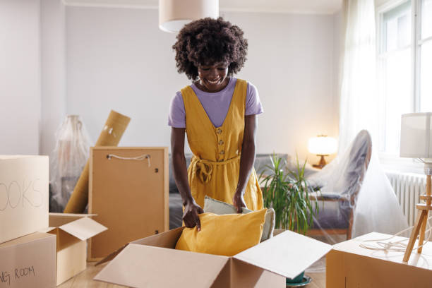 istock An African American woman unpacking moving boxes 1960346465