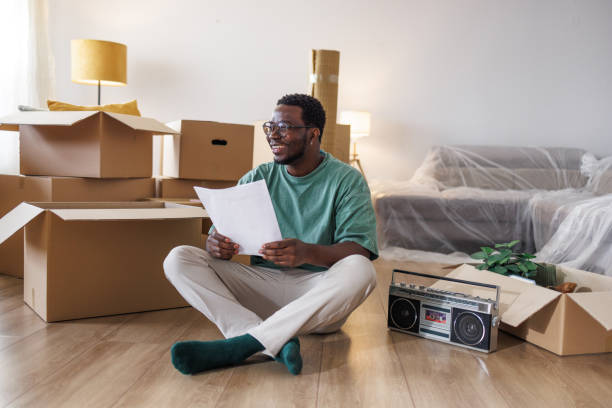 istock Young man reading a new home contract 1960347555