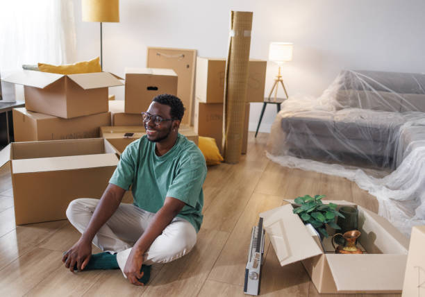 istock Young man with moving boxes in new home 1960347559