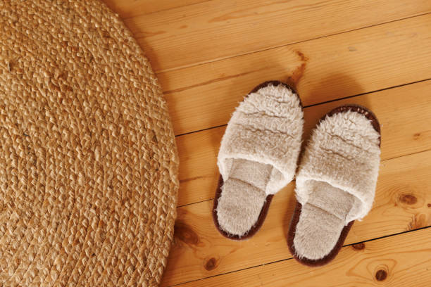 istock Cozy slippers on wooden floor. Flatlay. 1960353969