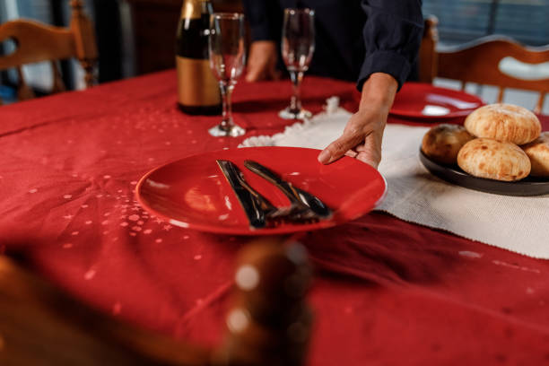 istock Caring mature woman setting the table for a romantic dinner date 1960361989