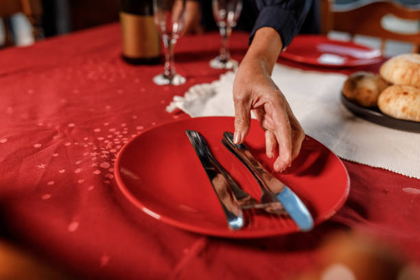 istock Caring mature woman setting the table for a romantic dinner date 1960361992