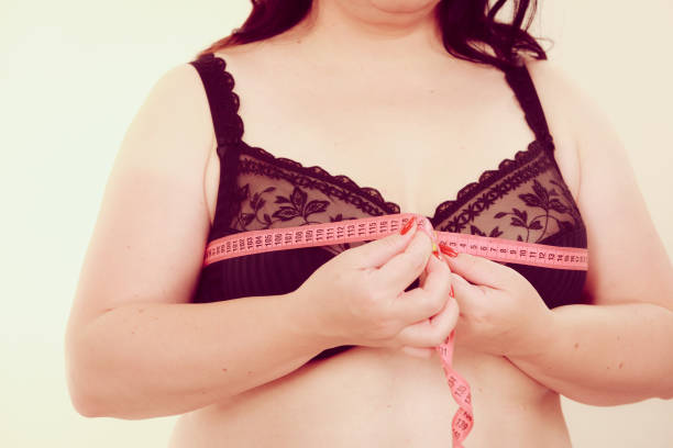 istock Woman measuring her chest breasts bust size 1960365271