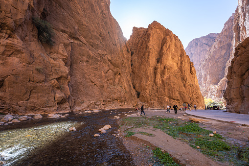 Tinerhir, Morocco - January 03, 2024:  Tourists exploring the popular steep Todgha Gorge (also Todra) north of Tinghir in the south of the Atlas Mountains.