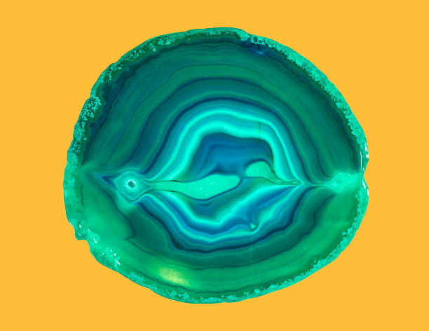 Close-up shooting of a green agate stone mineral surface isolated on white background. Its a macro shot shows nature beautiful details with back lit. Agate is a kind of natural gemstone. Abstract pattern. Good for Wallpaper texture background. Turquoise, green.