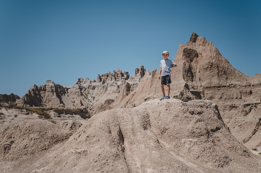 Young boy exploring the rock formations of Badlands National Park.