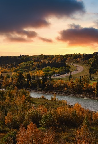 A cloudy colourful sunset glowing over the river valley in Cochrane.