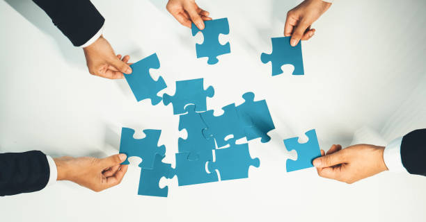 istock Top view panorama banner of business team assembling jigsaw puzzle. Shrewd 1960400603