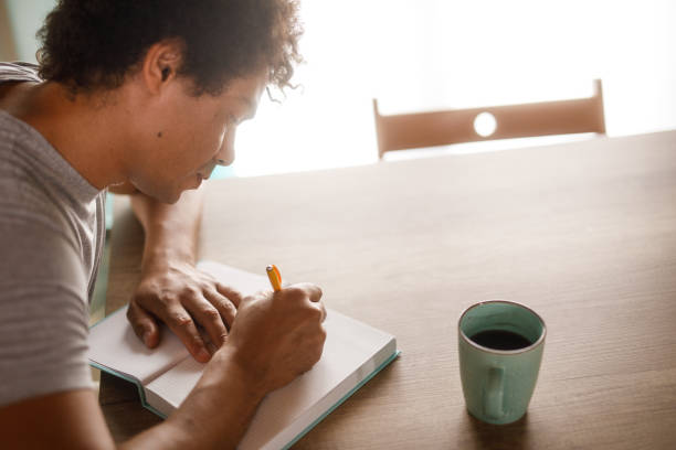 istock Man writing a ''to do list'' in a notepad 1960407990