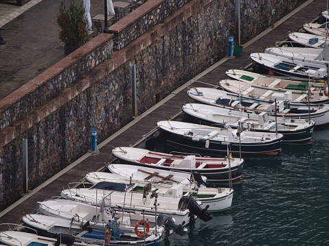 Small boats lined up at the harbor dock