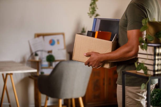 istock Man holding a box with his belongings when moving into new home 1960419589