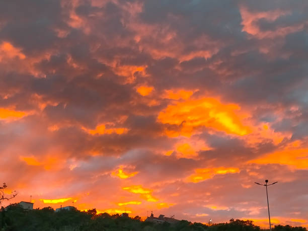 istock spectacular sunset with orange sky with clouds 1960424820