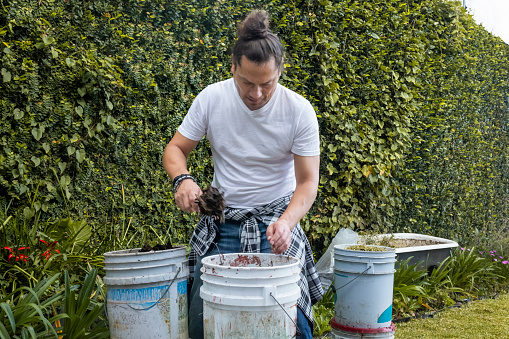 A gardener feeding earthworms