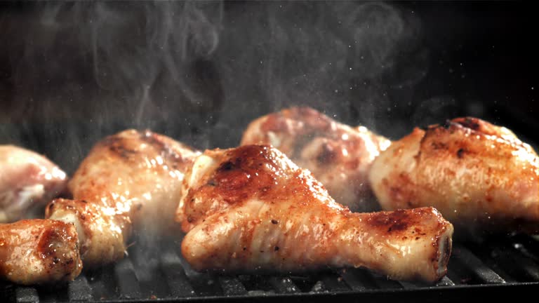 Chicken legs are fried in a pan. Filmed on a high-speed camera at 1000 fps.