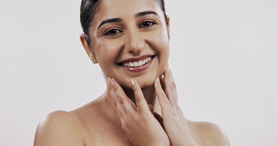 Skincare, cosmetics and portrait of Indian woman on a white background for wellness, facial and makeup. Dermatology, cosmetology and face of happy person with beauty, salon and aesthetic in studio