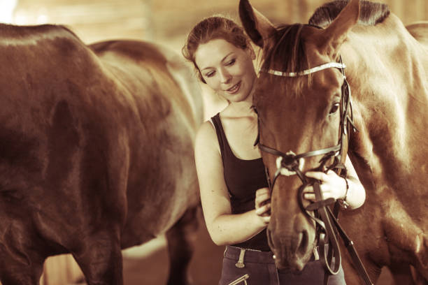 istock Woman hugging brown horse in stable 1960477031