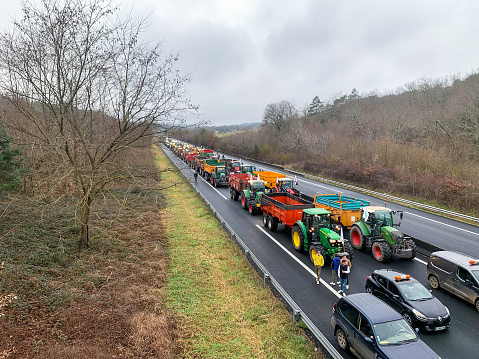 PERIGUEUX, FRANCE - JANUARY 24: French farmers blocking a road in protest of rising costs and excessive regulation, on January 24, 2024 in Périgueux, Dordogne, FranceFrench farmers blocking a road in protest of rising costs and excessive regulation, on January 24, 2024 in Périgueux, Dordogne, France