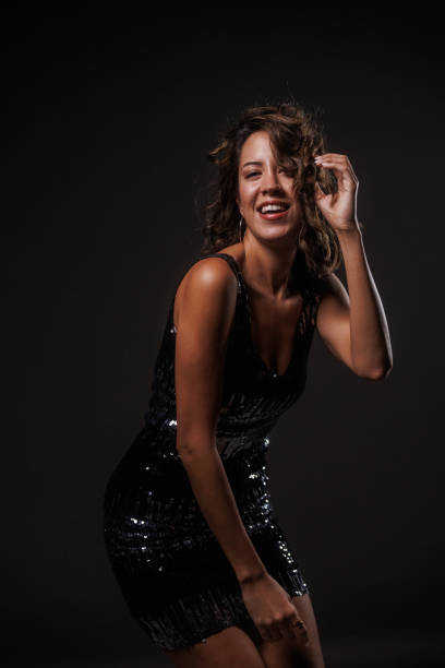 istock Cool young woman dancing against dark gray background 1960495535