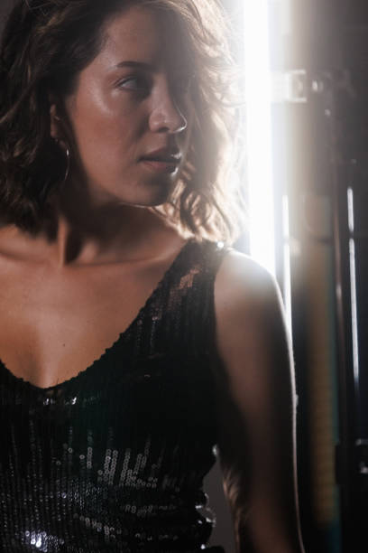 istock Cool young brunette in a sparkly dress, contemplating 1960498151