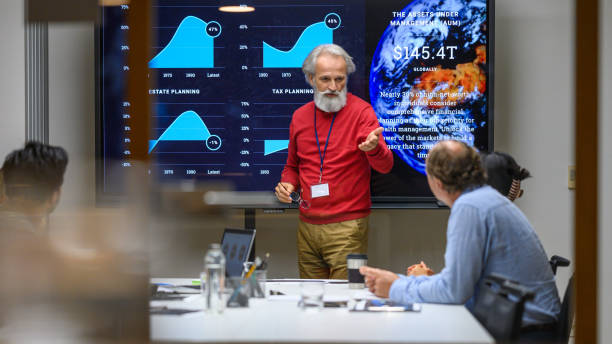 istock Senior man presenting report in meeting room 1960514649