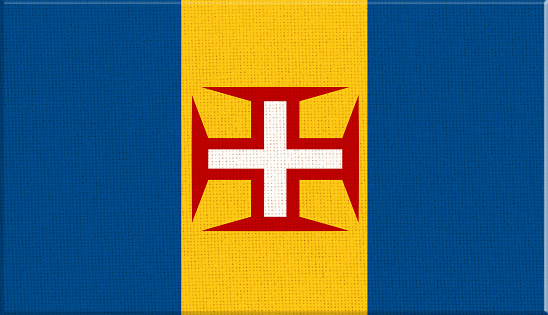 Flag of Madeira. flag of Portuguese island on fabric surface. Madeira symbol on textured background. Fabric texture. Island country. Flag illustration. Autonomous Region of Madeira