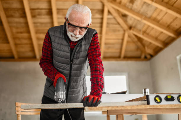 istock Senior male carpenter working at his workshop with electric saw 1960534504