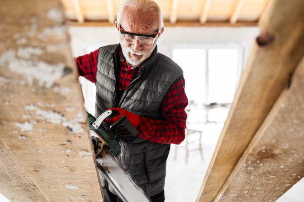 istock Elderly Carpenter with Chainsaw Expertise 1960534508