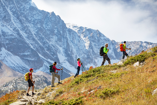Small group  of people trekking in mountains