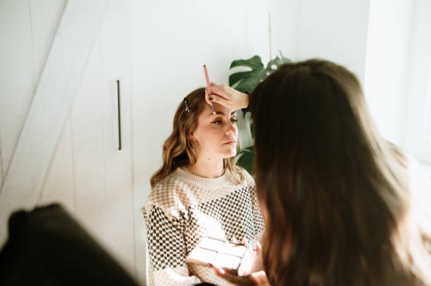 istock Make up artist working on a female customer 1960563213
