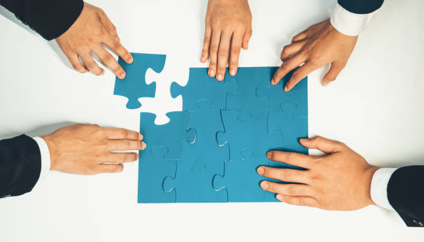 istock Top view panorama banner of business team assembling jigsaw puzzle. Shrewd 1960571874