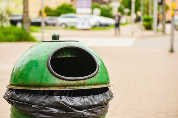 istock Green pastic garbage bin or can on street 1960586005