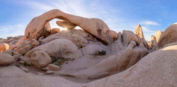This is a wide angle photograph of a small tent setup at the Jumbo Rocks Campground in Joshua Tree National Park in the Mojave Desert, California.