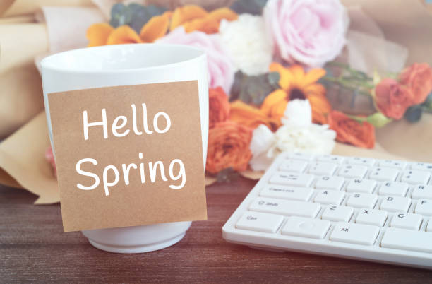 istock Sticky not on a cup of coffee with text Hello Spring 1960594390
