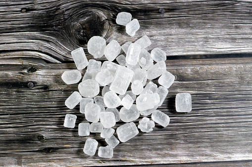 pile of rock crystal sugar candy lumps, a type of confection composed of relatively large sugar crystals, Misri or crystallized sugar lumps, confectionery mineral, its origins in India and Iran, selective focus