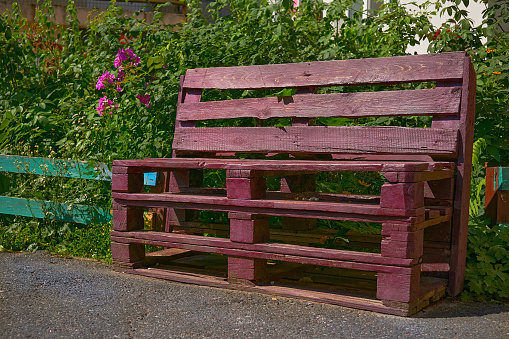 Bench made from wooden boxes on a personal plot in the yard