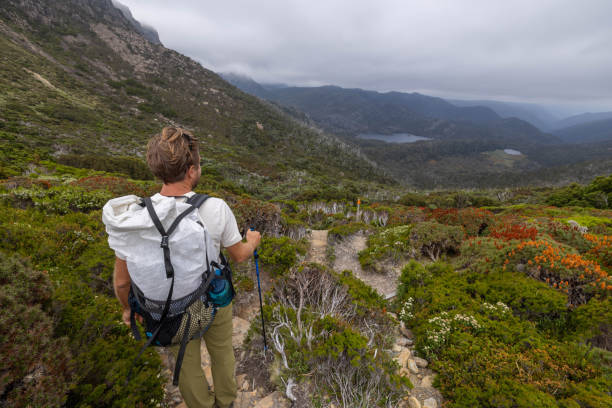 istock Endurance Journey: Man Hiking with Stormy Sky on Long-Distance Trail 1960614872