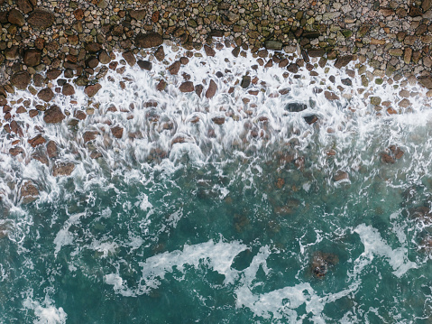 Sea waves and large pebbles from above