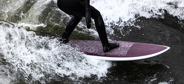 Young man in the surf on Taghazout beach, Morocco. This a from a motordrive series of a lesson where he gets onto the board and then overbalances. the sequence starts with him crouched on the board and ends with him overbalancing backwards off the board.