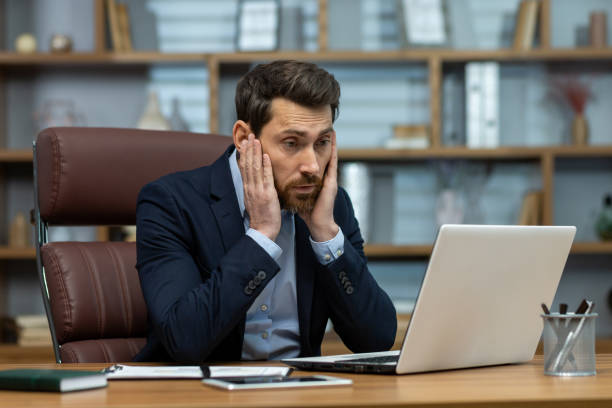 istock Concentrated senior businessman analyzing data on laptop in a classic office setup 1960690493