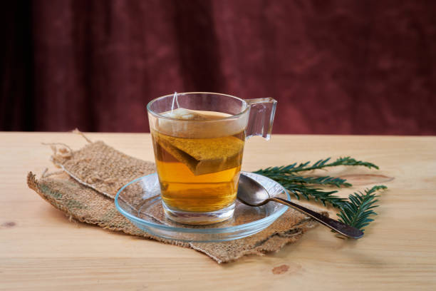 Chamomile sachet in glass cup on rustic wooden table